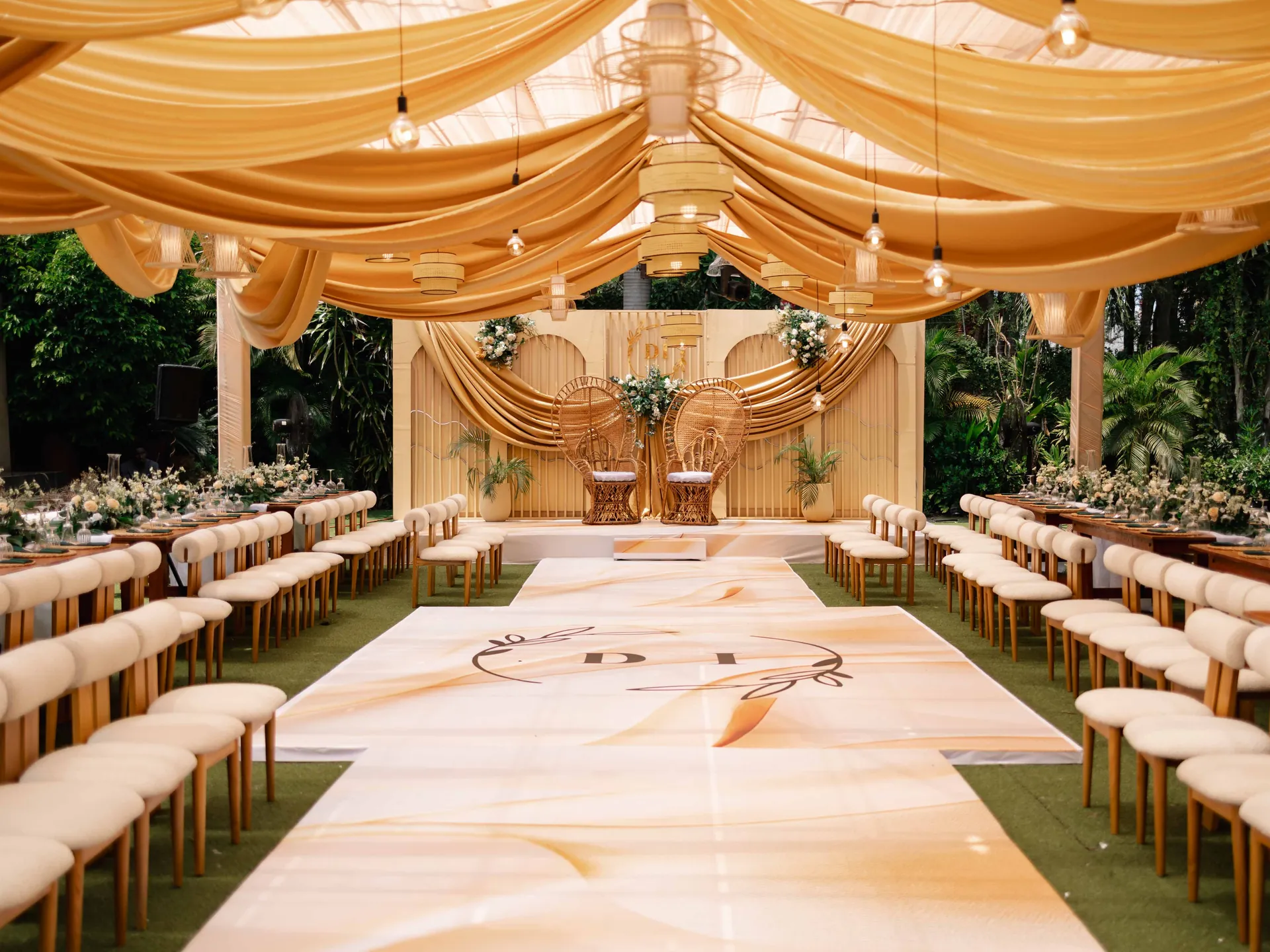Elegant outdoor wedding reception with draped canopy and floral tablescapes